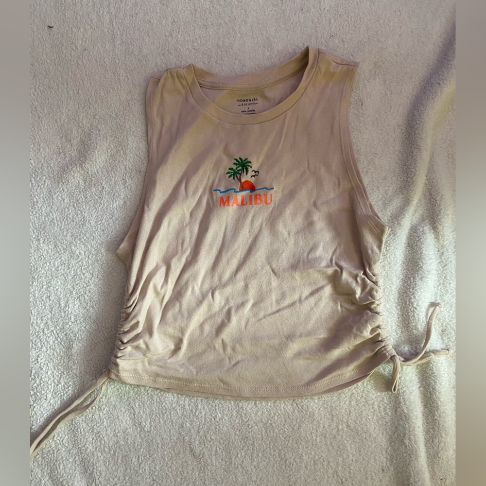 tan crop with strings to tighten.